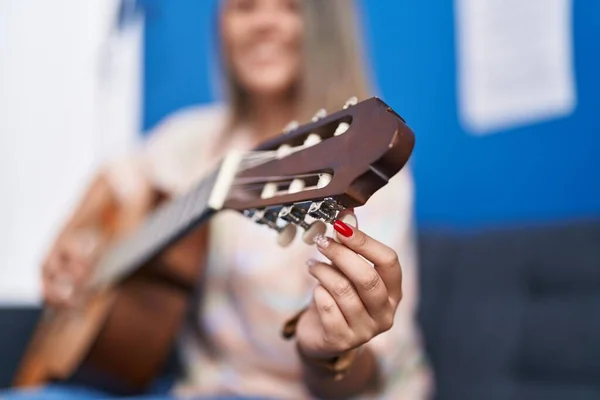 stock image Young hispanic woman musician playing classical guitar at music studio