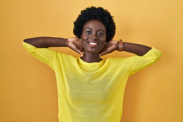African Young Woman Standing Yellow Studio Relaxing Stretching Arms Hands — Stock Photo, Image