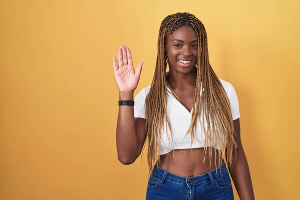 Afroamerikanerin Mit Geflochtenen Haaren Die Vor Gelbem Hintergrund Steht Und — Stockfoto