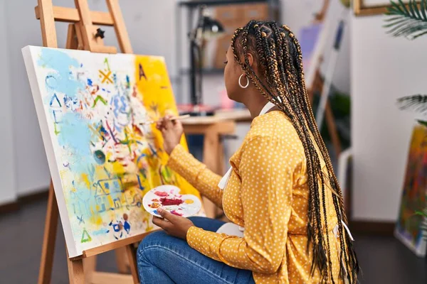 African american woman artist drawing with doubt expression at art studio