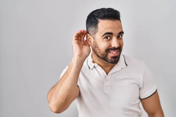Mladý Hispánec Vousy Oblečený Neformálního Oblečení Bílém Pozadí Usmívá Rukou — Stock fotografie
