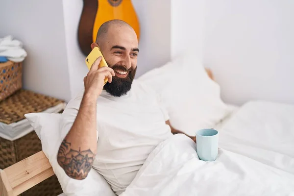 Young Bald Man Talking Smartphone Drinking Coffee Bedroom — Stock Fotó