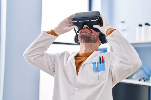 stock image Young man scientist using virtual reality goggles at laboratory