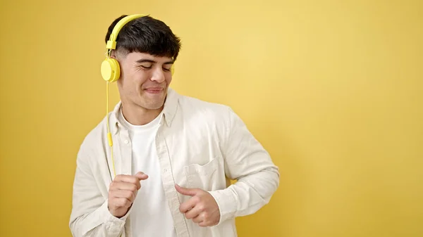 Молодий Іспаномовний Чоловік Слухає Музику Танцює Над Ізольованим Жовтим Тлом — стокове фото