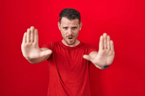 Young Hispanic Man Standing Red Background Doing Stop Gesture Hands — Stockfoto