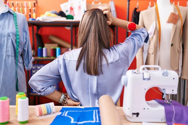 Hispanic Young Woman Dressmaker Designer Atelier Room Backwards Thinking Doubt — Stock Photo, Image