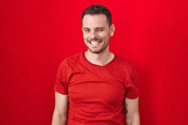 Young Hispanic Man Standing Red Background Winking Looking Camera Sexy — Stock fotografie
