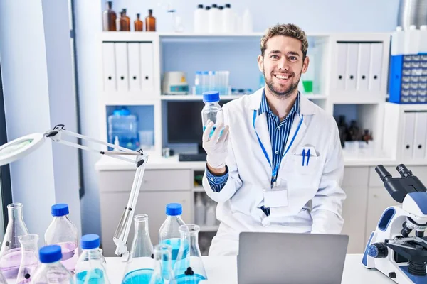 Young Man Scientist Using Laptop Holding Bottle Laboratory — Stockfoto
