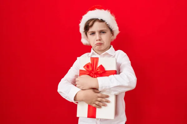 Little Caucasian Boy Wearing Christmas Hat Holding Gifts Depressed Worry Stock Picture