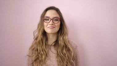 Young beautiful hispanic woman smiling confident wearing glasses over isolated pink background