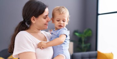 Mother and son smiling confident standing at home
