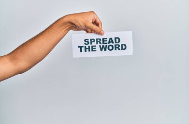 Hand of caucasian man holding paper with spread the word message over isolated white background