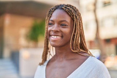 African american woman smiling confident looking to the side at street