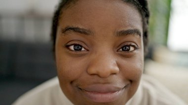 African american woman smiling confident sitting on sofa at home