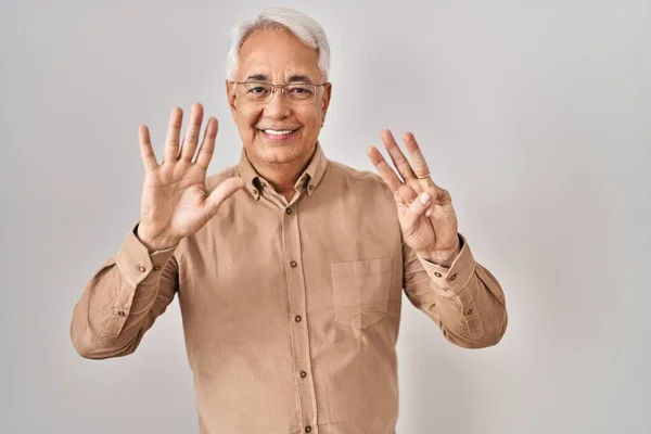 Hispanic Senior Man Wearing Glasses Showing Pointing Fingers Number Eight — стоковое фото
