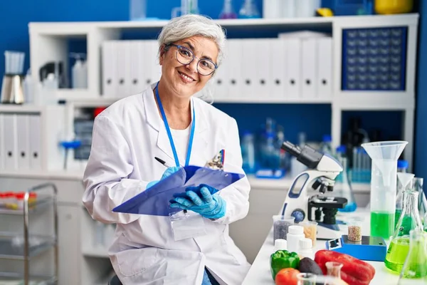 Middle Age Woman Wearing Scientist Uniform Writing Document Laboratory — 图库照片