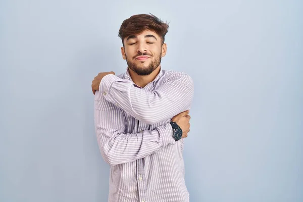 Arab Man Beard Standing Blue Background Hugging Oneself Happy Positive — Stock Photo, Image