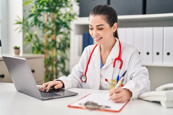 Νεαρή Όμορφη Ισπανίδα Γιατρός Χρησιμοποιώντας Laptop Γράφοντας Έγγραφο Στην Κλινική — Φωτογραφία Αρχείου