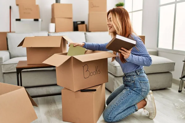 Young Caucasian Woman Smiling Confident Putting Books Cardboard Box New — Stock Photo, Image