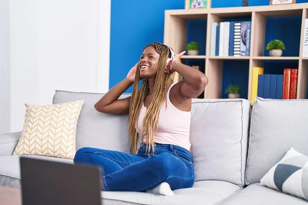 African American Woman Dancing Listening Music Sitting Sofa Home — Stockfoto