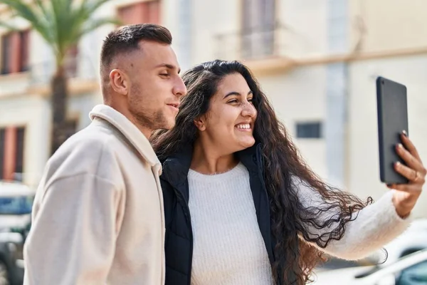 Man and woman smiling confident having video call at street