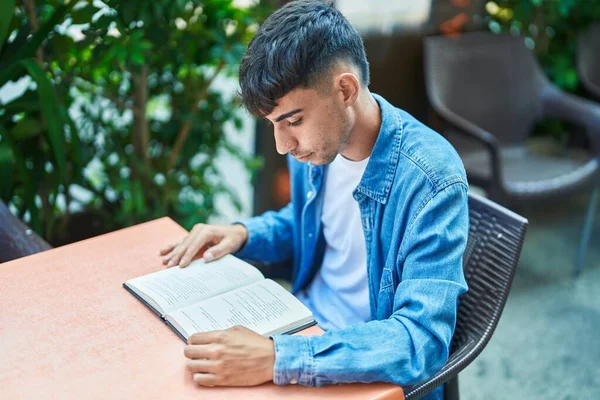 Young Hispanic Man Reading Book Sitting Table Coffee Shop Terrace — Stok fotoğraf