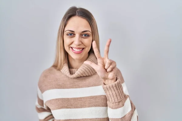 Young Blonde Woman Wearing Turtleneck Sweater Isolated Background Showing Pointing — Stock Photo, Image