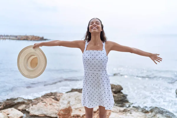 Joven Mujer Afroamericana Sonriendo Confiada Sosteniendo Sombrero Verano Playa —  Fotos de Stock