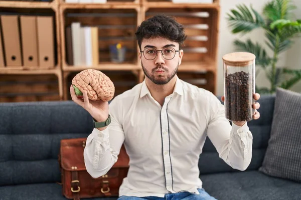 Hispanic Man Med Skägg Arbetar Terapikontoret Håller Hjärnan Och Kaffebönor — Stockfoto