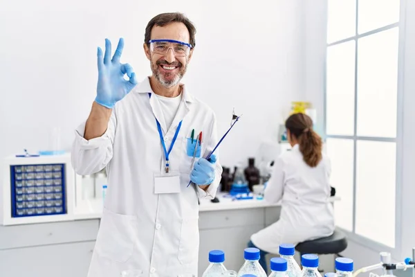 Middle Age Man Working Scientist Laboratory Doing Sign Fingers Smiling — Stock fotografie