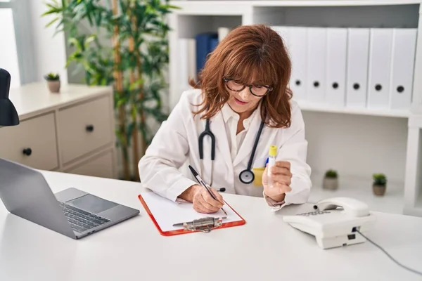 Middle Age Woman Wearing Doctor Uniform Writing Paperwork Holding Test — Stok fotoğraf