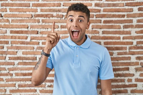 Brazilian Young Man Standing Brick Wall Pointing Finger Successful Idea — Stock Photo, Image