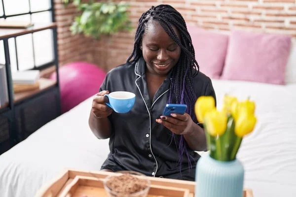 Afro Amerikalı Bir Kadın Yatak Odasında Akıllı Telefon Kullanarak Kahvaltı — Stok fotoğraf