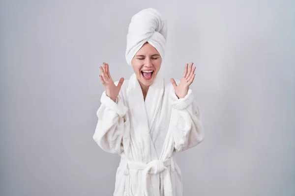 Blonde Caucasian Woman Wearing Bathrobe Celebrating Mad Crazy Success Arms — Stock Photo, Image