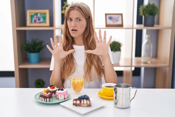 Young Caucasian Woman Eating Pastries Breakfast Afraid Terrified Fear Expression — Stock Photo, Image