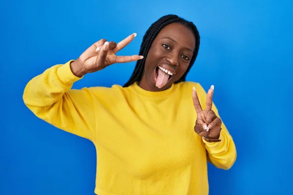 Beautiful Black Woman Standing Blue Background Smiling Tongue Out Showing — Fotografia de Stock