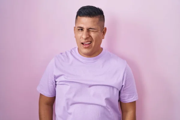 Young Hispanic Man Standing Pink Background Winking Looking Camera Sexy — Zdjęcie stockowe