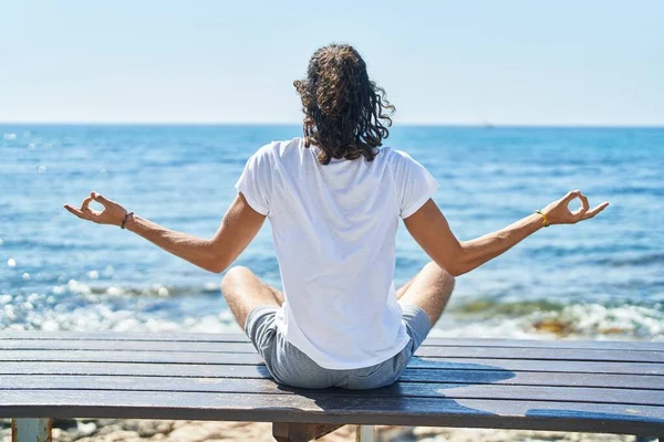 Young Hispanic Man Doing Yoga Exercise Sitting Bench Seaside — Stock Fotó