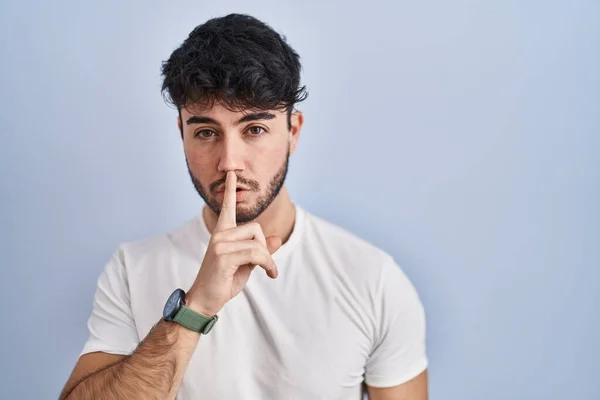 Hispanic Man Beard Standing White Background Asking Quiet Finger Lips — Stock fotografie