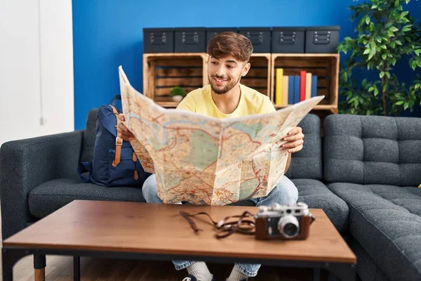 Young Arab Man Looking City Map Sitting Sofa Home — Fotografia de Stock