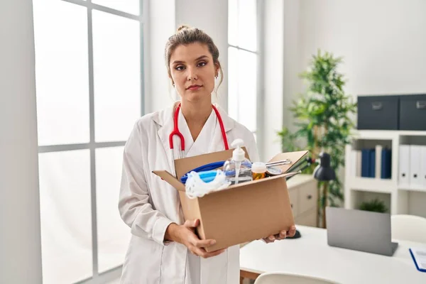 Young Doctor Woman Holding Box Medical Items Relaxed Serious Expression — Stock Photo, Image