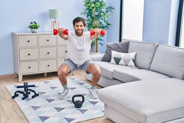 Young Hispanic Man Smiling Confident Using Dumbbells Training Home — Stockfoto