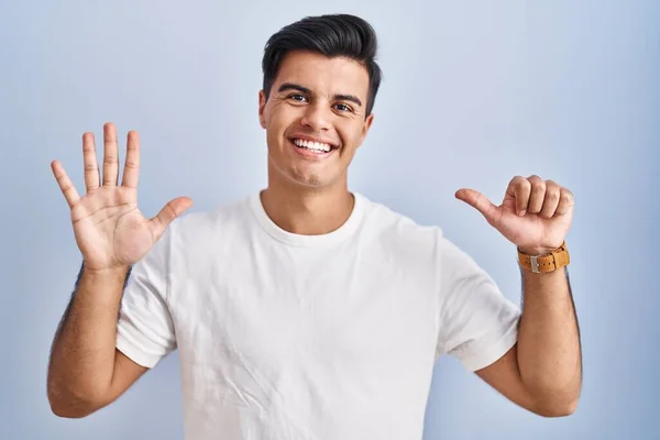 Hispanic Man Standing Blue Background Showing Pointing Fingers Number Six — Stock Fotó