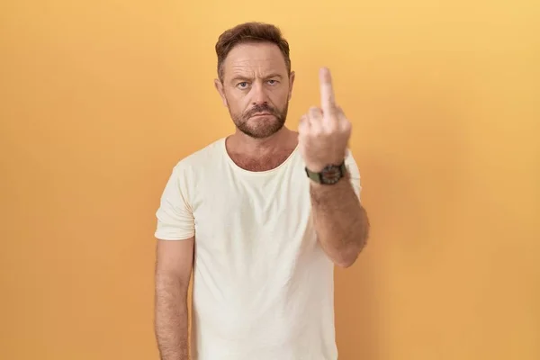 Middle Age Man Beard Standing Yellow Background Showing Middle Finger — Φωτογραφία Αρχείου