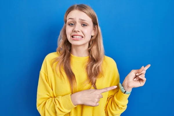 Junge Kaukasische Frau Steht Über Blauem Hintergrund Und Zeigt Besorgt — Stockfoto