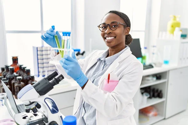 アフリカ系アメリカ人女性科学者が実験室で試験管を持っている — ストック写真