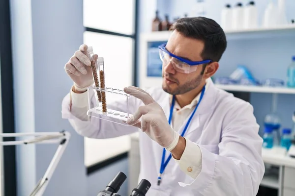 Young Hispanic Man Scientist Holding Test Tubes Laboratory — Fotografia de Stock