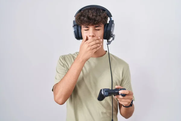 Hispanic Teenager Playing Video Game Holding Controller Bored Yawning Tired — Stock Photo, Image