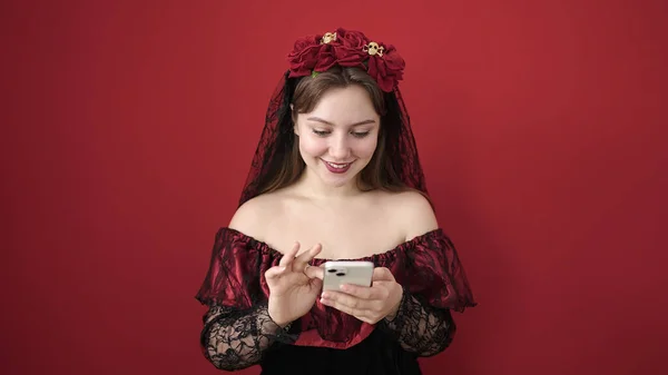 Young Blonde Woman Wearing Katrina Costume Using Smartphone Isolated Red — Stock Photo, Image