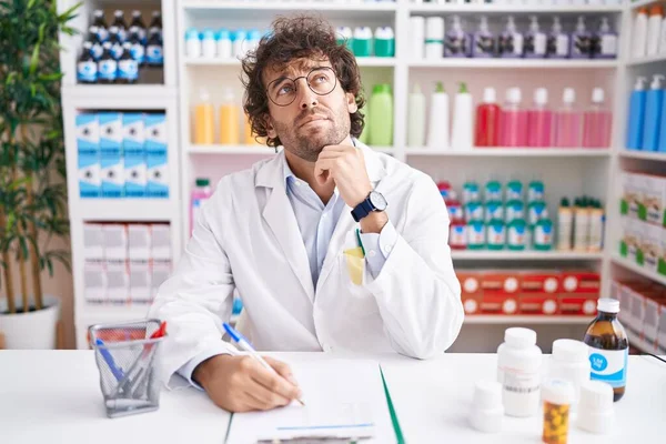 Hispanic Young Man Working Pharmacy Drugstore Hand Chin Thinking Question — Stock Photo, Image